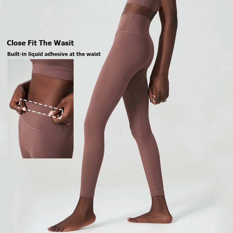 Model wearing stylish women's ankle-length yoga leggings with close fit and built-in liquid adhesive for secure waist support.